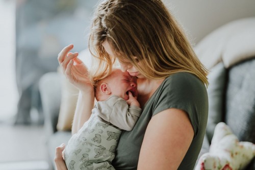 Ein kleines Baby bei einer Frau auf dem Arm.