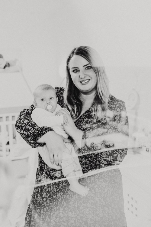 Eine Frau hält ein kleines Baby auf dem Arm.