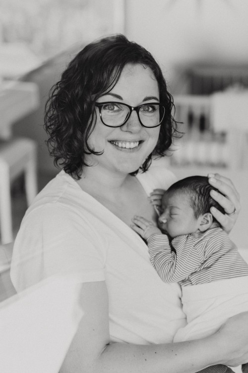 Eine Frau hält ein Baby an ihrer Brust.