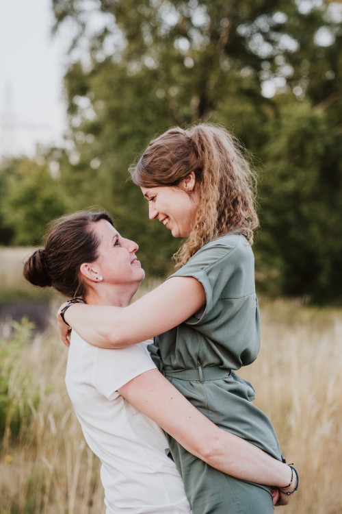 Eine Frau hält eine andere Frau hoch.
