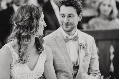 Ein schwarz-weißes Bild von einem Brautpaar, das sich liebevoll anschaut.