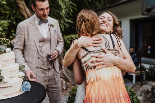 Eine Braut umarmt eine Frau.