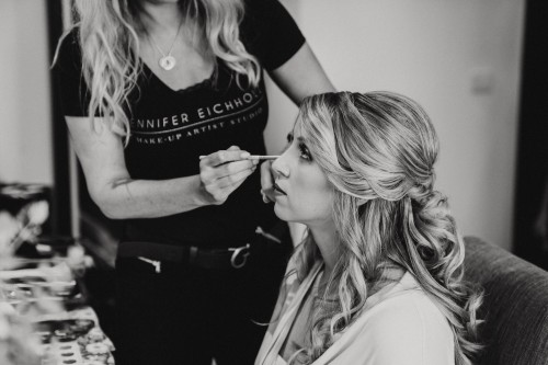 Ein schwarz-weißes Bild von einer Frau die geschminkt wird.